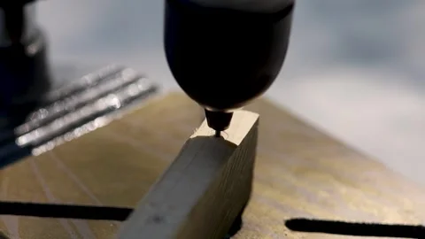 The drill bit drills a wooden block. Close-up ans sunlight. Stock Footage 245076110