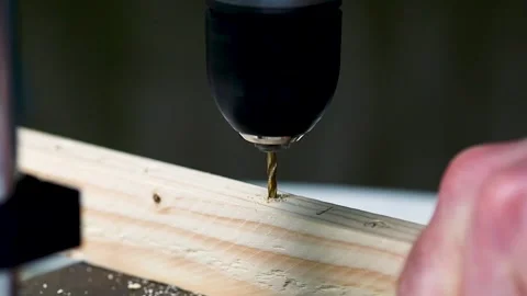 The drill bit drills a wooden block. Close-up. Stock Footage 245986043