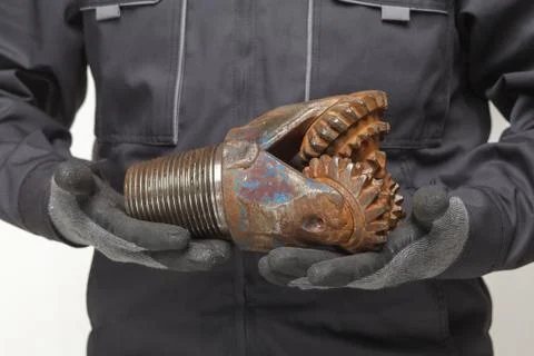 Drill bit in hands Stock Photos