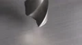 The drill bit make a hole in aluminum surface. Real time capture HD Footage
