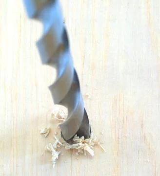 Drill bit in pine Stock Photos