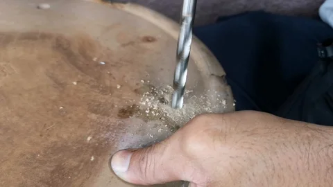 The drill bit is rotating to punch holes in the board. Stock Footage 121305445