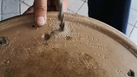 The drill bit is rotating to punch holes in the board. Stock Footage 121305534