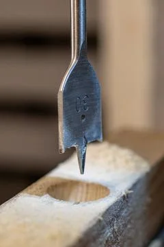 Drill bit in woodworking process. Stock Photos