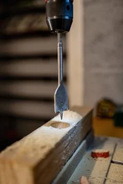 Drill bit in woodworking process. Stock Photos