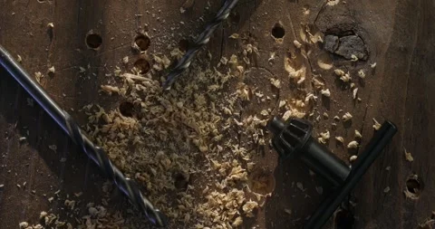 Drill Bits and Wood Shavings on a Rustic Wooden Surface Stock Footage 294163630