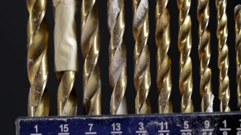 Drill bits close up dolly shot of different sized bits used for drill holes in w Stock Footage 135832824