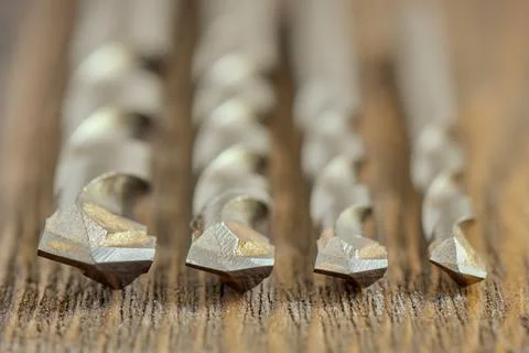 Drill bits cutting edges closeup, four carbide cutters for drilling concrete Stock Photos