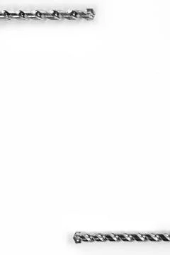 Drill bits of different sizes isolated over white background with copy space Stock Photos