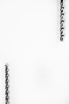 Drill bits of different sizes isolated over white background with copy space Stock Photos