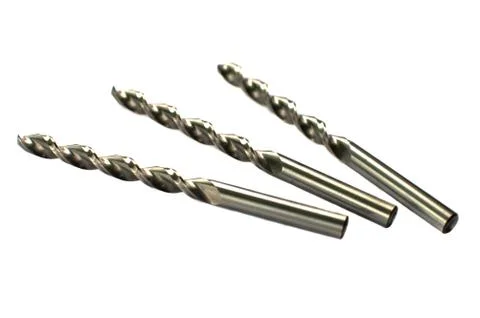 Drill bits of different sizes, isolated on white background. Фото