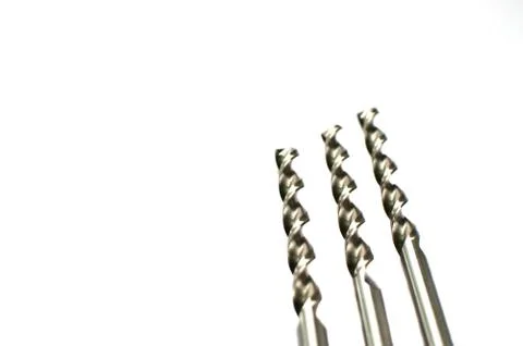 Drill bits of different sizes, isolated on white background. Фото