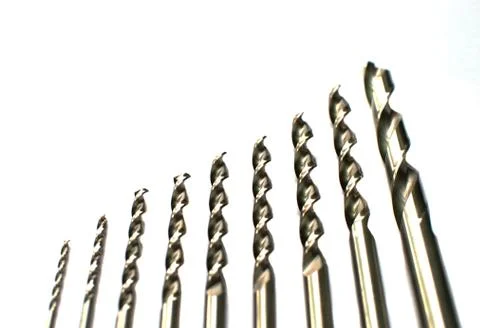 Drill bits of different sizes, isolated on white background. Фото