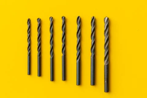 Drill bits kit on the colordul surface isolated, equipment dor a repairman Stock Photos