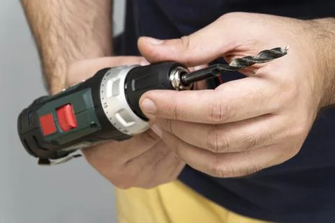 Drill bits. Screwdriver and bits. Replacing a bit on a screwdriver. Stock Photos