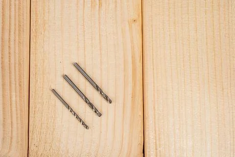 Drill bits on wooden background for construction projects Stock Photos