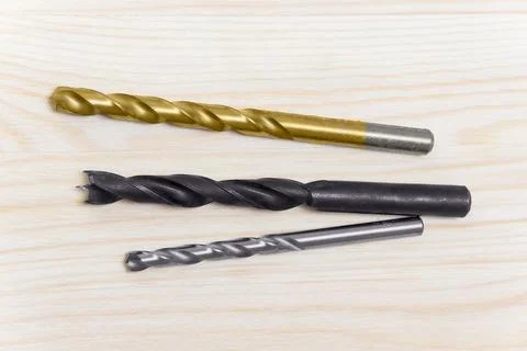 Drill bits on wooden background Stock Photos