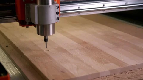 Drill the circle in motion on the board installed in the cnc wood router machine Stock Footage 143667853