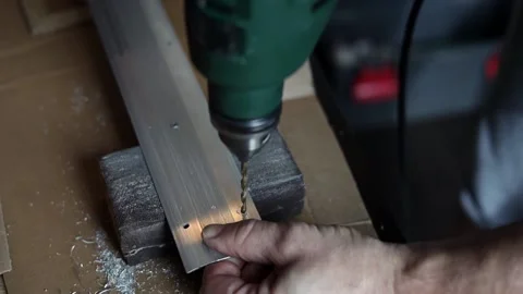 Drill close-up. The master drills holes in the metal panel. Stock Footage 197445159