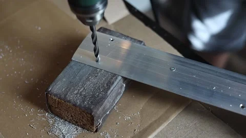 Drill close-up. The master drills holes in the metal panel. Stock Footage 197445177