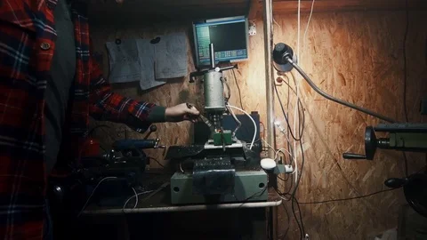 Drill cnc machine close-up, master brush away shavings Stock Footage 84576386