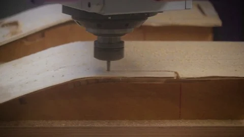 The drill of the CNC is making a pattern on the wood in Ireland Stock Footage 70807959