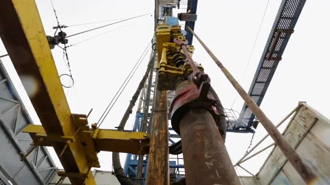 The drill on the drilling rig is lowering underground. Stock Footage 169024252