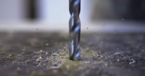 The drill drills into the surface of the countertop, producing green shavings. Stock Footage 303045886