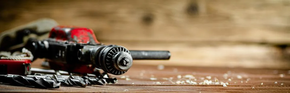 Drill with drills on the table. Stock Photos