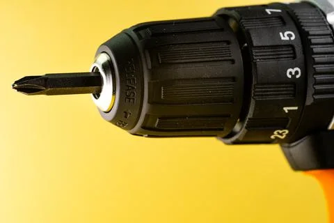Drill driver on yellow background Stock Photos