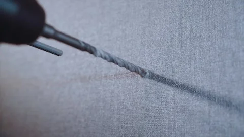The drill goes into the wall in slow motion Stock Footage 169713627