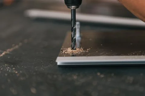 Drill hammered into a surface in a workshop Stock Photos