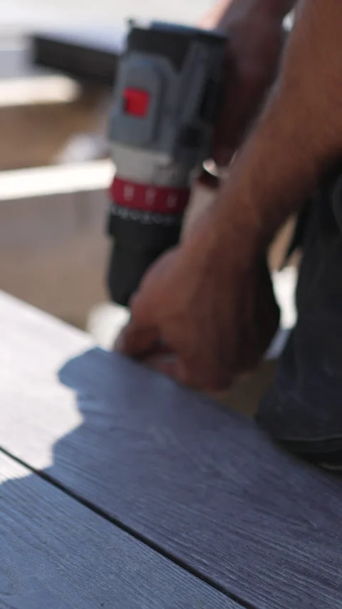 Drill Hands Deck man installing composite planks during construction Stock Footage 313984642