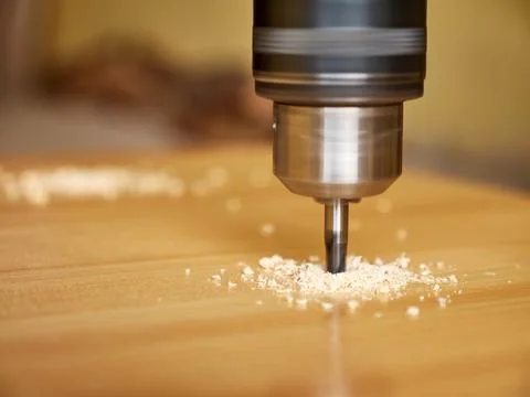 Drill a hole in the board with a drill. Carpentry works. A tool for working.. Stock Photos