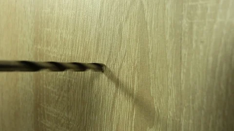 Drill a hole with a drill bit closeup Stock Footage 85250605