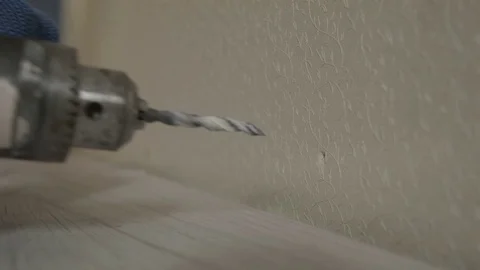 Drill a hole in the wall and he hammers dowel Stock Footage 73742763