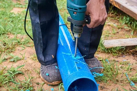 Drill holes in a plastic pipe Stock Photos