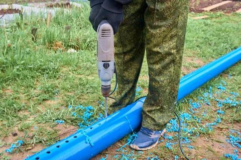 Drill holes in a plastic pipe Stock Photos