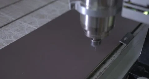 Drill is lowered into a sheet of plastic and begins to cut part of the caviar Stock Footage 135166918