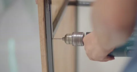 Drill pilot holes before inserting the nut. Stock Footage 222621155