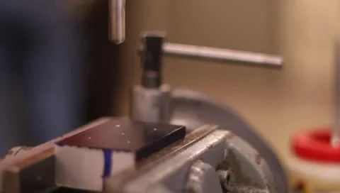 Drill press drilling metal block with oil Stock-Footage 10688656
