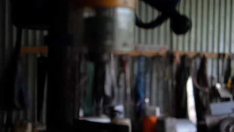 Drill press in old garage hanging tools on back wall Stock Footage 195982037
