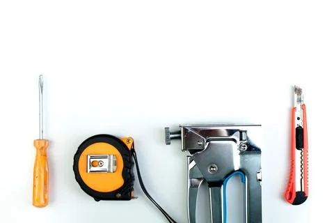 Drill, putty knife, screwdrivers construction stapler on white background. .. Stock Photos