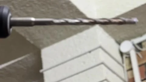 Drill with rotating bit in close up, construction tool ready for work, home Stock Footage 337117345