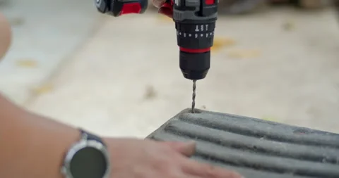 Drill the rusty nut head to remove the damaged nut.Old rusty nuts are a problem  Stock Footage 282381791