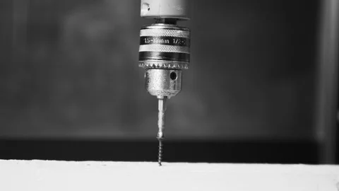 Drill, screwdriver slowly tightening the screw into the wood. unscrew Stock Footage 104408087