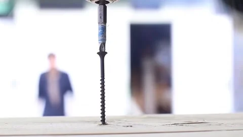 The drill screws a self-tapping screw into the board Stock Footage 135238109