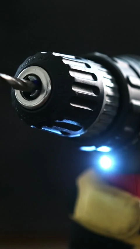 Drill Tool With Metal Bit and Blue Light on Work Surface Stock Footage 339023878
