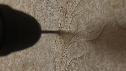 Drill a wall with a perforator Stock Footage 97716904