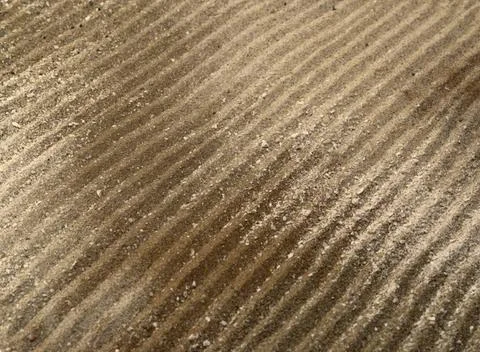 Drilled lines in brown sand surface abstract full frame background with di... Stock Photos